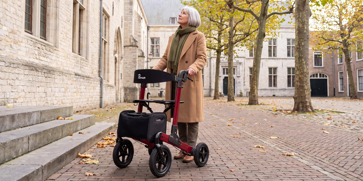 Parvum Luxo Air in ruby red on a square with plane trees and old stone buildings; a woman looks up.