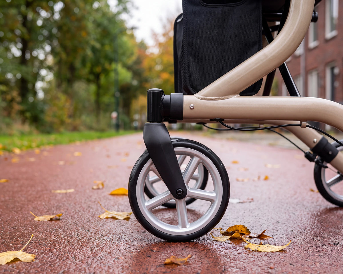 Close-up of the silver front wheel of the Parvum SuperLight Plus in champagne on a wet bike path.