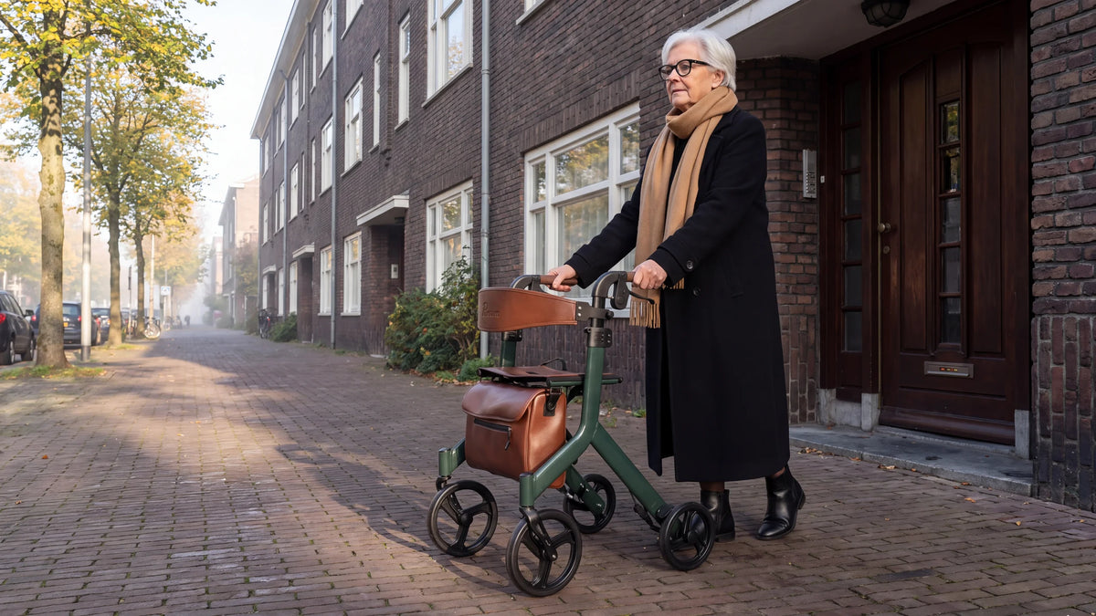 Parvum Vesta in moss green outside a brick apartment building; a woman in a black wool coat looks down the street.